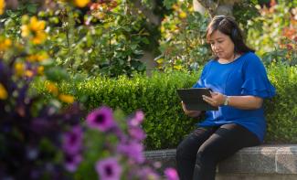 women sitting down looking at tablet