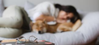 blurry image of woman and dog sleeping