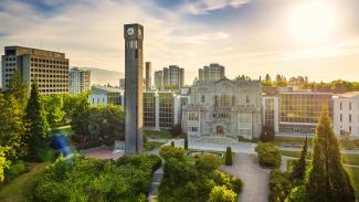 Aerial shot of the UBC Vancouver clocktower with warm summer sun in the background