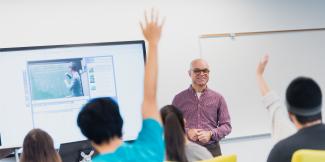 Faculty member in a classroom with students